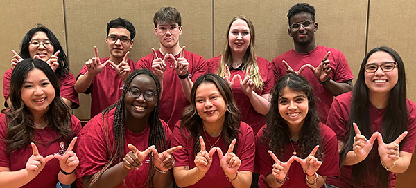 photo of ten peer advisors wearing red t-shirts and smiling at the camera